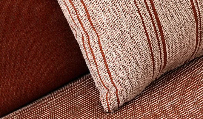 Close-up of a textured brown and red striped fabric