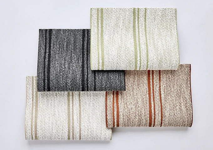 Four woven fabric samples with different patterns on a light gray background
