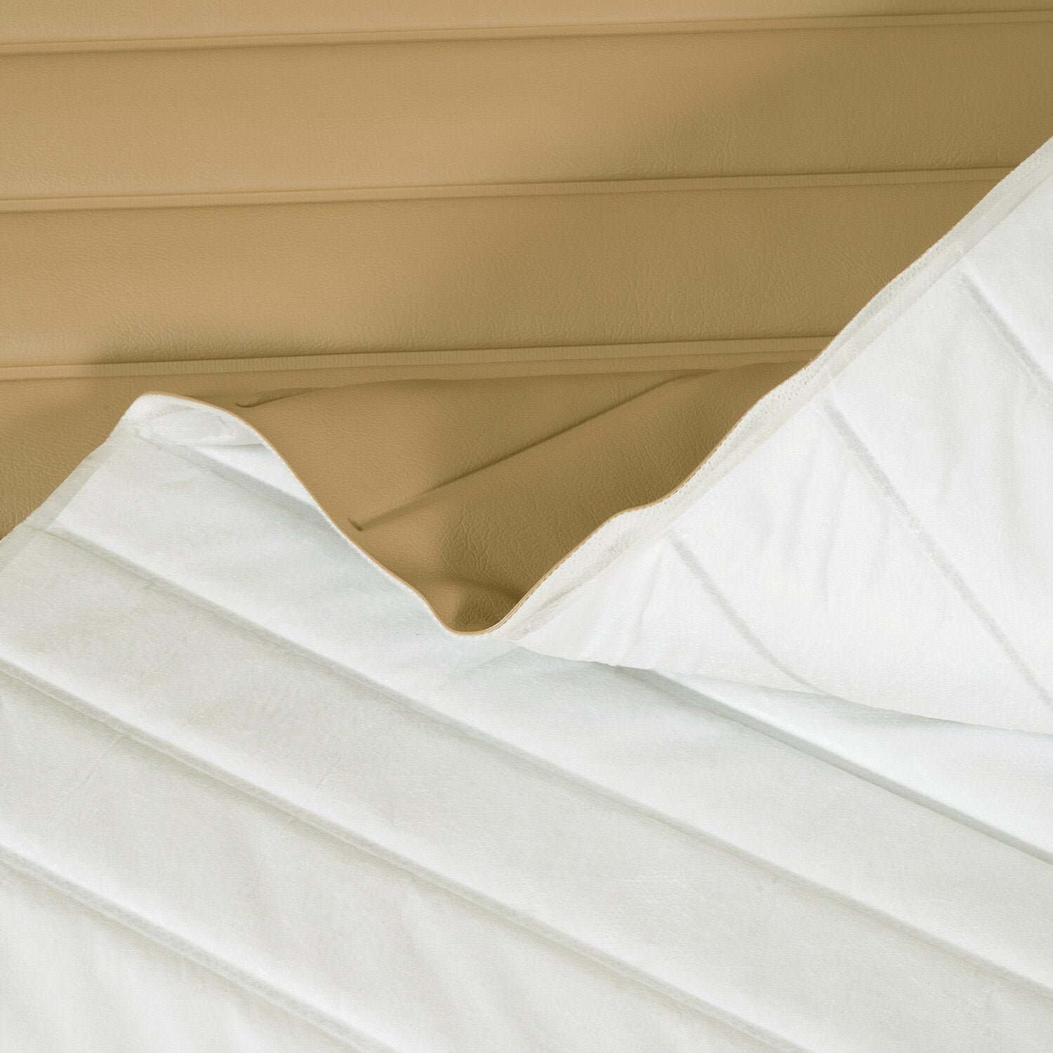 Close-up of white fabric with a beige background