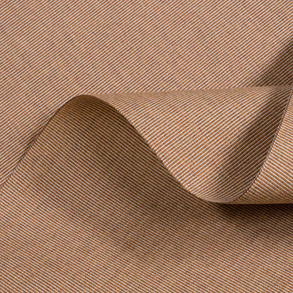 Close-up of brown fabric with a subtle pattern