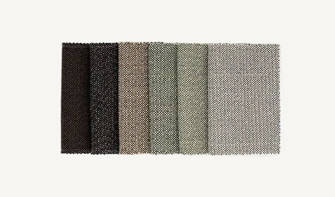 Color swatch with black, dark gray, light gray, and white textured fabric samples on a white background