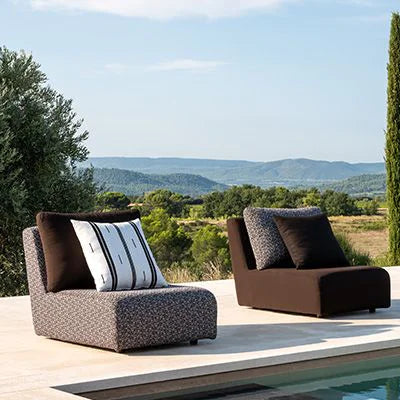 Outdoor furniture set by a pool with scenic landscape