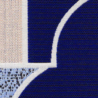 Close-up of a textured fabric with blue, beige, and multicolor pattern