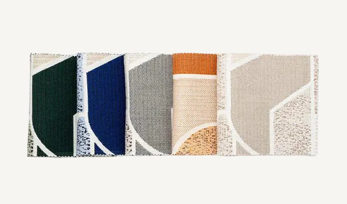 Rectangular woven mat with geometric pattern on a white background
