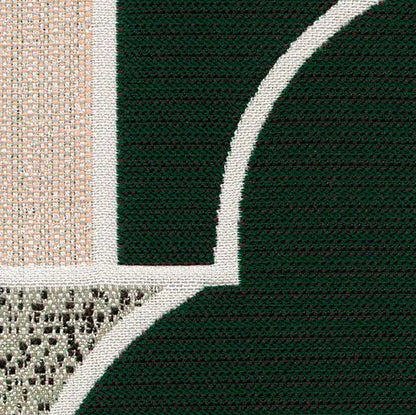 Close-up of a textured fabric with green, beige, and brown patterns.