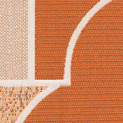 Close-up of a textured orange and beige patterned rug