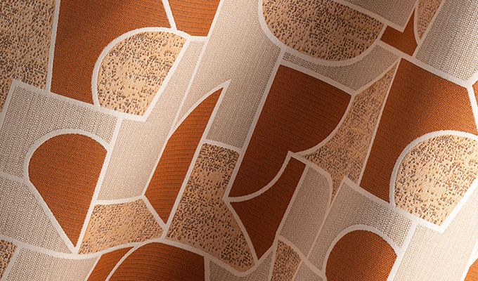 Close-up of fabric with a pattern of hearts in brown and beige tones.