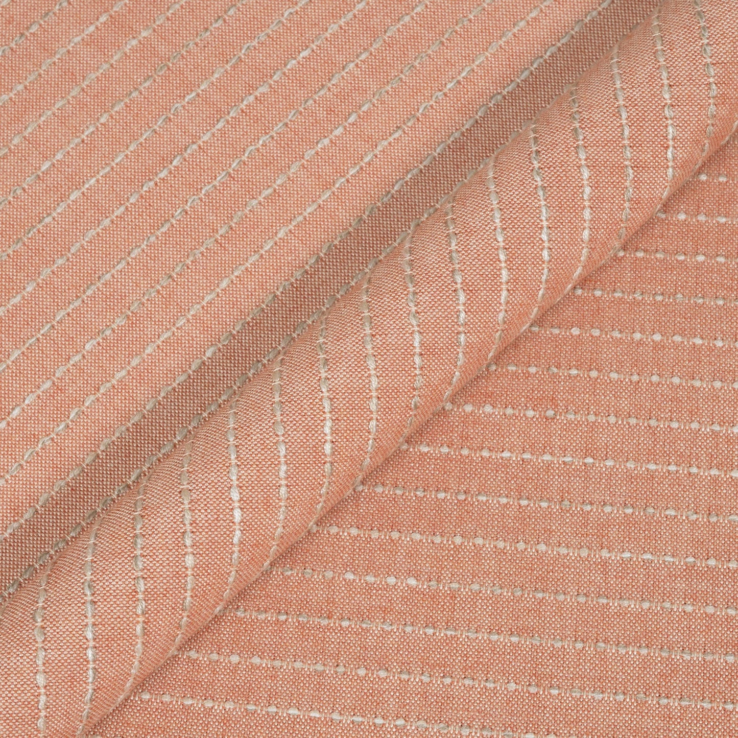 Close-up of pink fabric with subtle white stripes