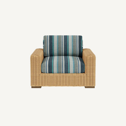 Wicker armchair with striped cushions on a white background