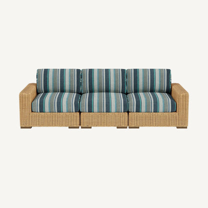 Wicker outdoor sofa with striped cushions on a white background