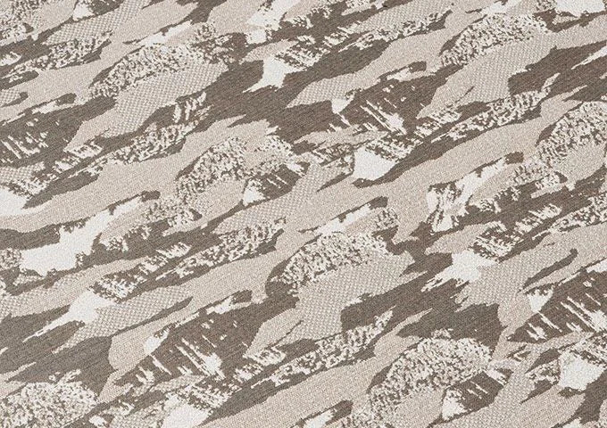Textured fabric with a camouflage pattern in shades of brown and gray.