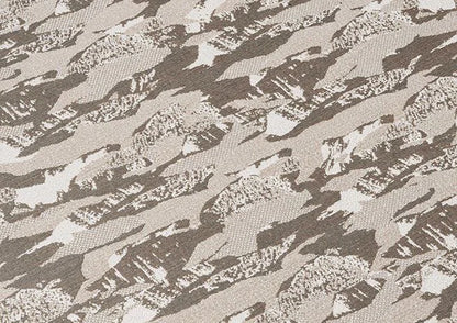 Textured fabric with a camouflage pattern in shades of brown and gray.