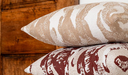 Two patterned pillows on a wooden surface