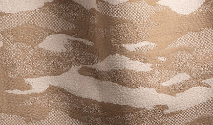 Close-up of a camouflage pattern fabric with brown, beige, and white colors.